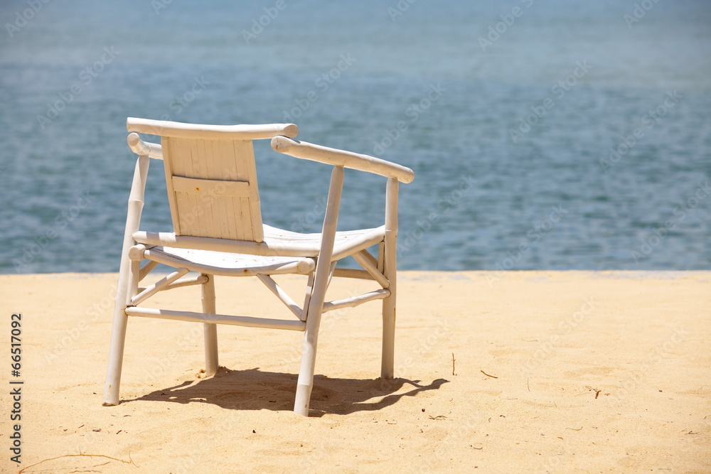 White wood beach chair on nice sand beach