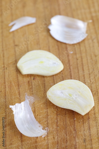Close - up Sliced garlic on brown wood