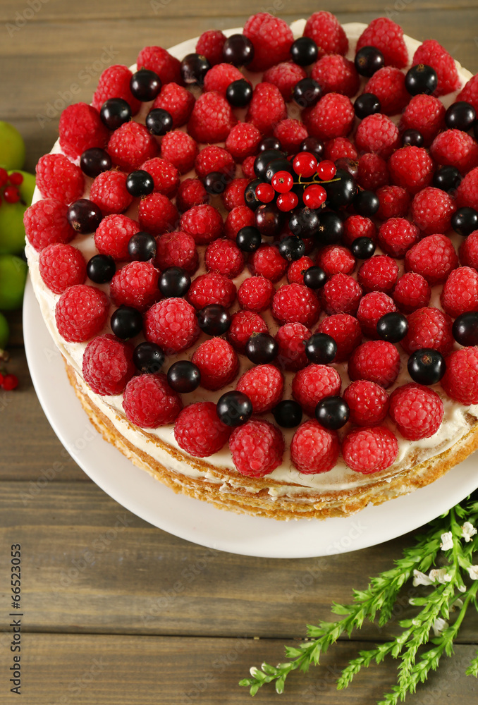 Tasty cake with fresh berries on wooden table Tasty cake with fresh berries on wooden table