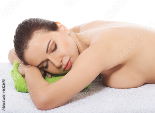 Woman lying at spa salon.