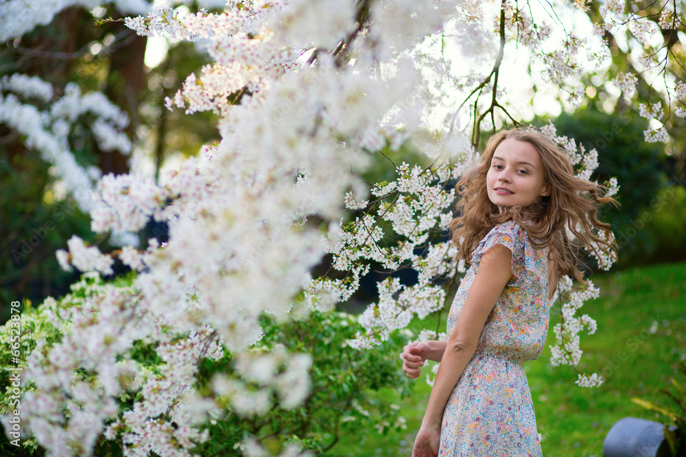 Young woman in blooming cherry garden Young woman in blooming cherry garden