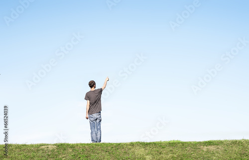 young man pointing to the sky