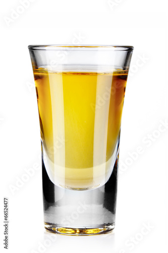 Gold tequila shot isolated on white photo