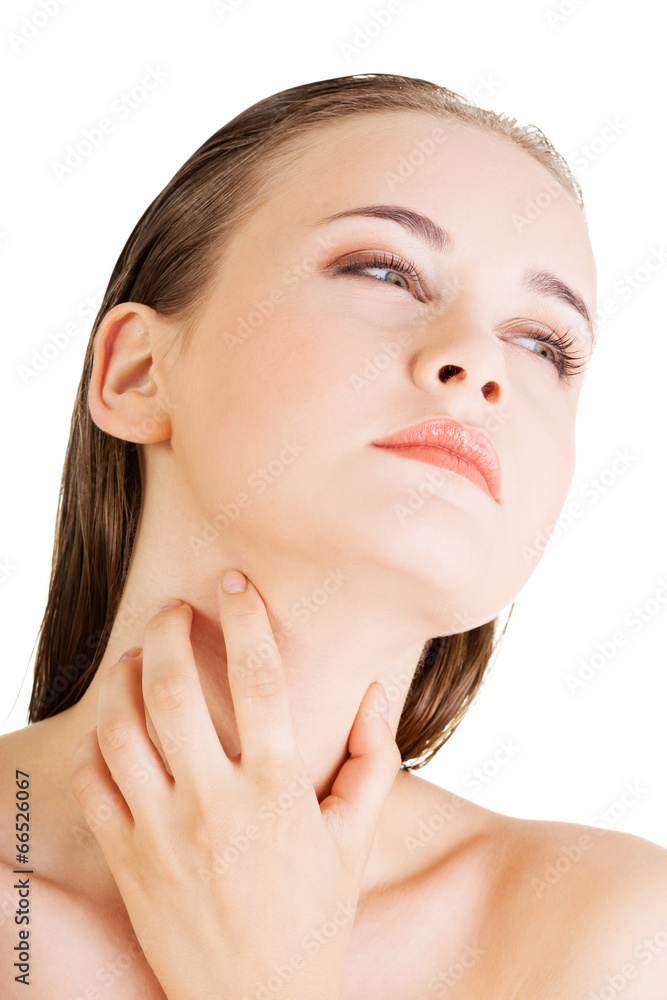 Beautiful sensual young woman touching her neck