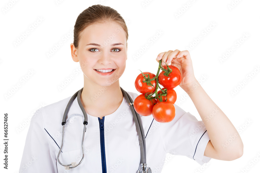 Female doctor holding healthy tomatoes. Female doctor holding healthy tomatoes.