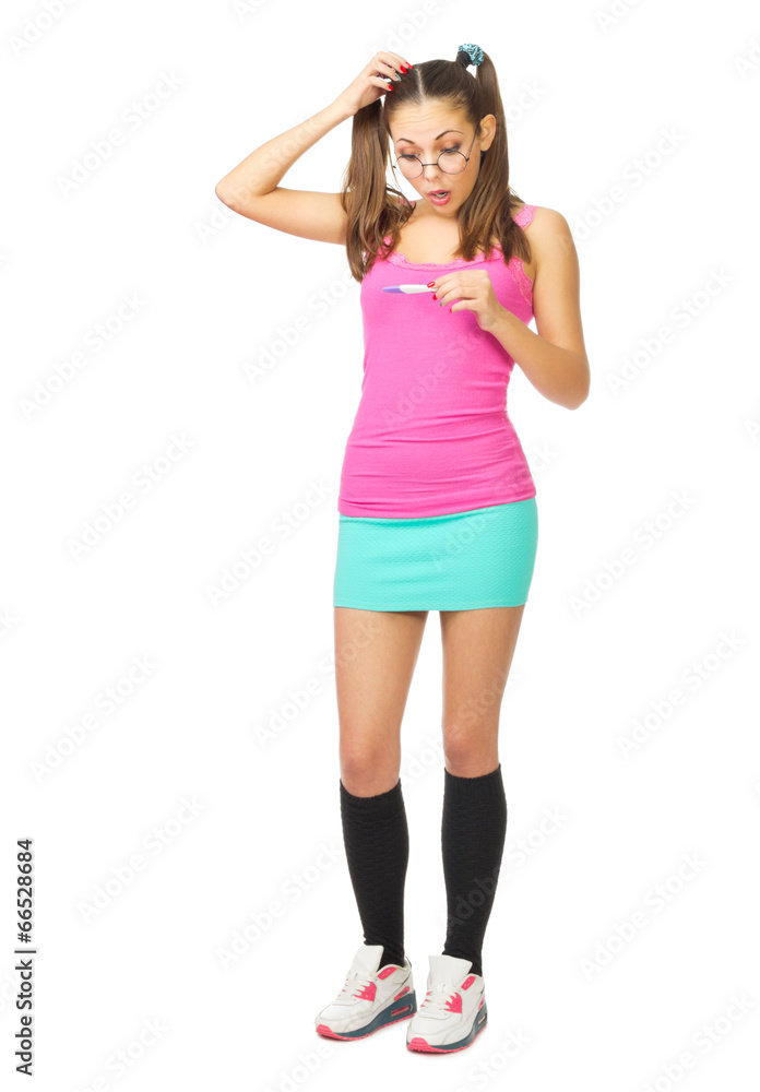 Fototapeta premium Confused schoolgirl with pregnancy test