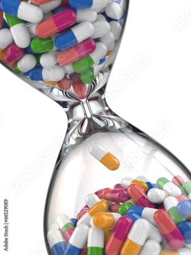 Time of medicine. Pills in hourglass photo