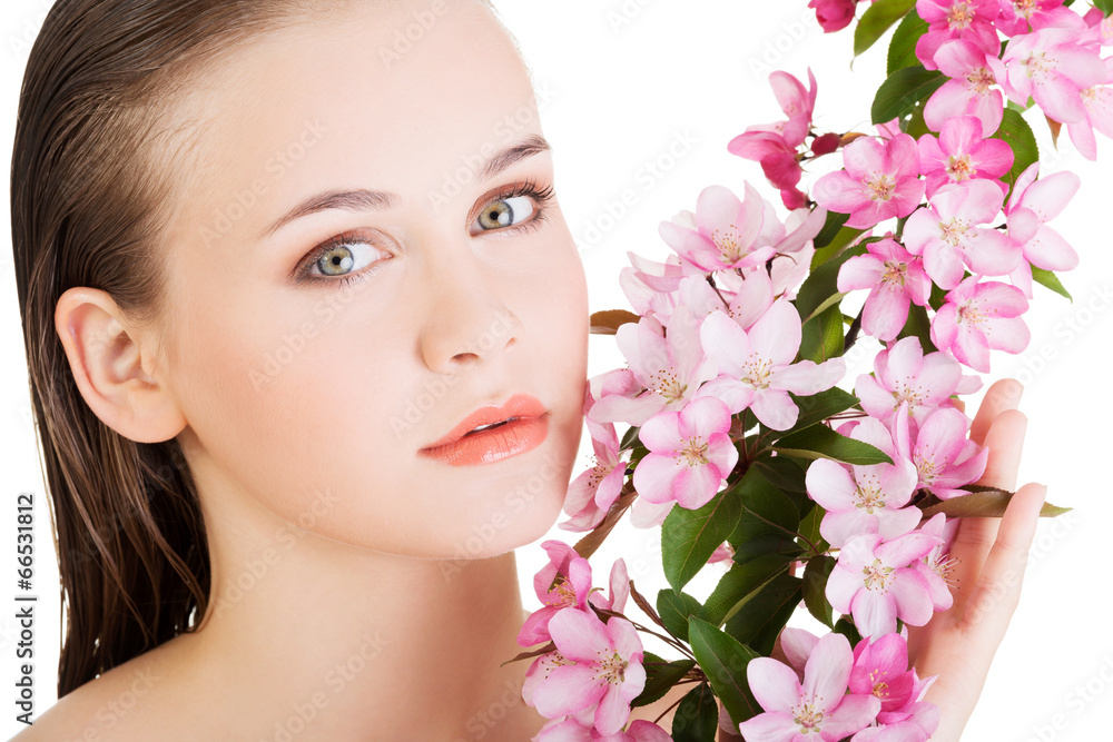 Woman with healthy clean skin and pink flowers Woman with healthy clean skin and pink flowers
