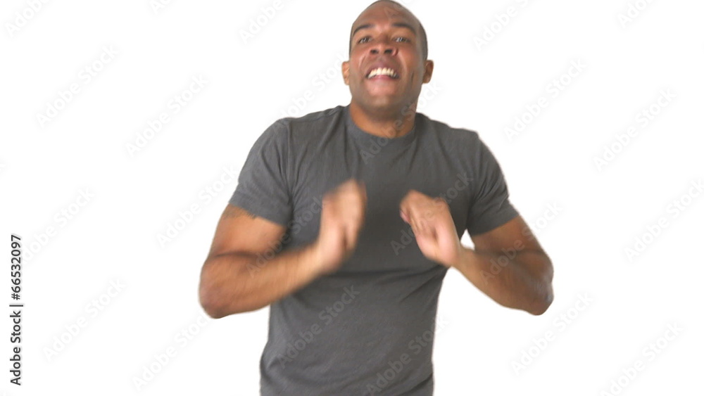 Young man in jeans and t-shirt dancing Young man in jeans and t-shirt dancing