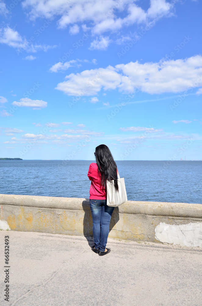 Woman looking into the distance at sea Woman looking into the distance at sea