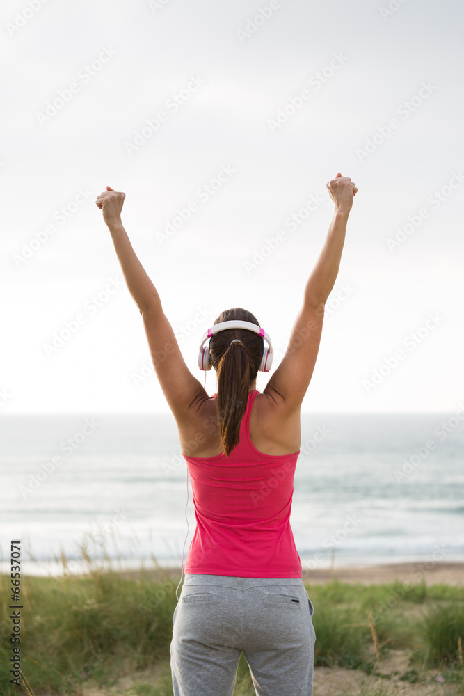 Fitness female athlete celebrating exercising achievement Fitness female athlete celebrating exercising achievement