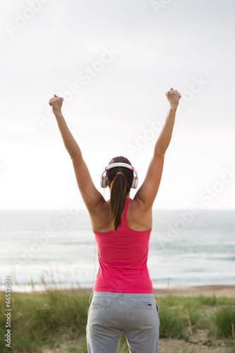 Fitness female athlete celebrating exercising achievement