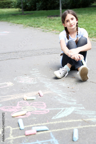 Cute girl drawing with chal...