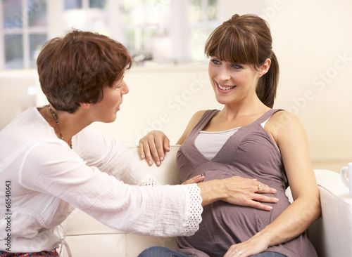 Pregnant woman talking to midwife photo