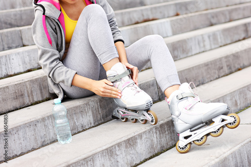 Woman putting on roller-blades