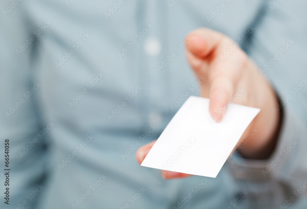 white business card in between female fingers white business card in between female fingers