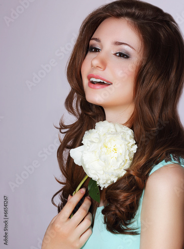 Freshness. Happy Woman with Peony Flower Smiling photo