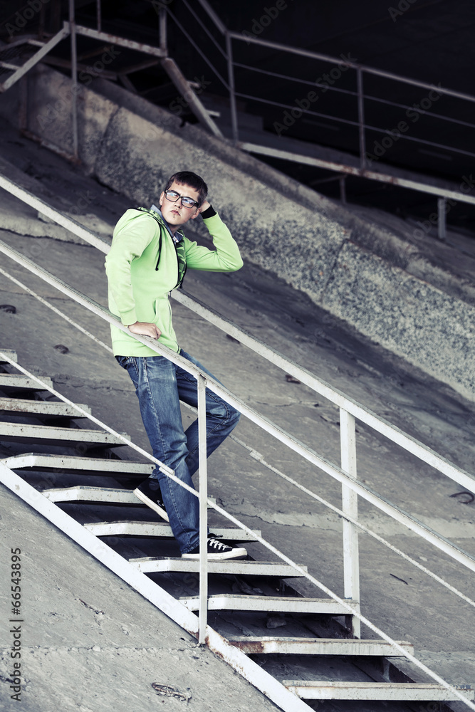 Young man standing on the steps Young man standing on the steps