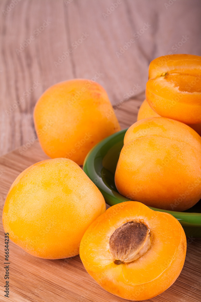 Fresh and ripe apricot on a wooden background