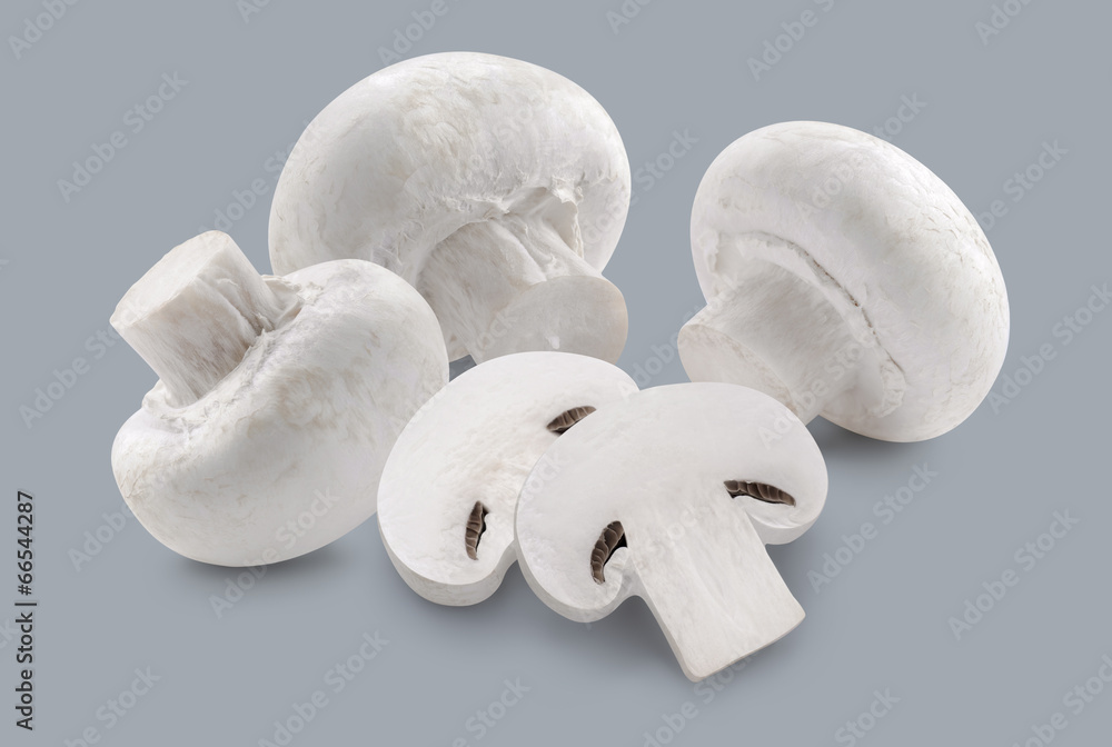 Whole button mushrooms and slices isolated on grey background Whole button mushrooms and slices isolated on grey background