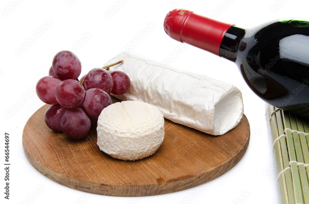 Fototapeta premium Composition of goat cheese on a wooden cutting board
