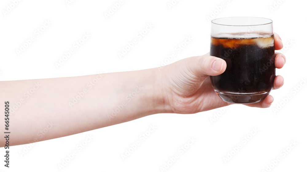 hand holds soft drink with ice in glass hand holds soft drink with ice in glass