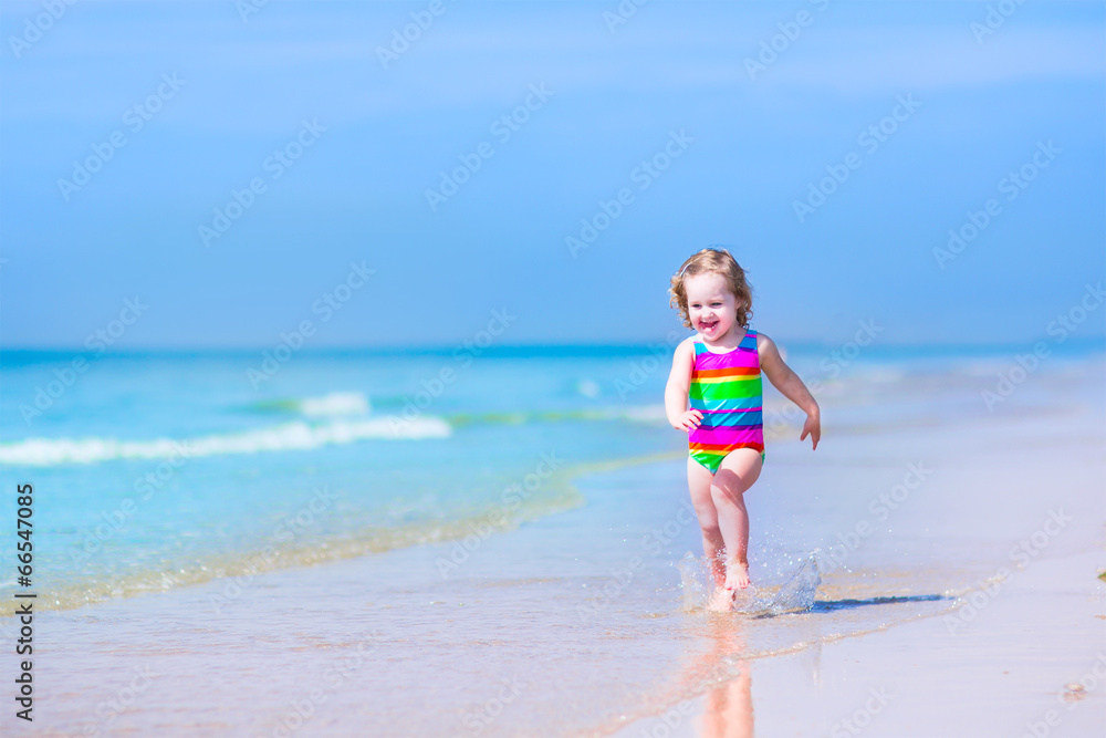 Little girl running on a beach
