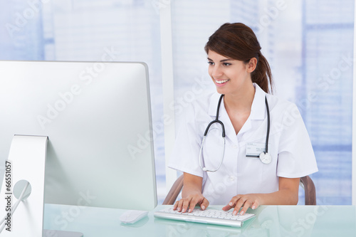 Doctor Using Computer At Desk In Clinic