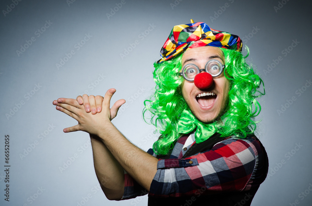 Funny clown against the dark background Funny clown against the dark background