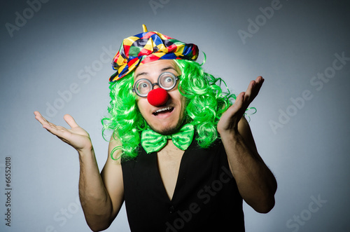 Funny clown against the dark background