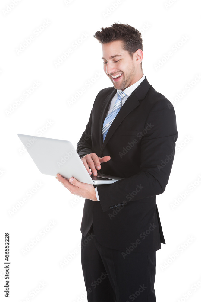 Confident Businessman Holding Laptop Over White Background Confident Businessman Holding Laptop Over White Background