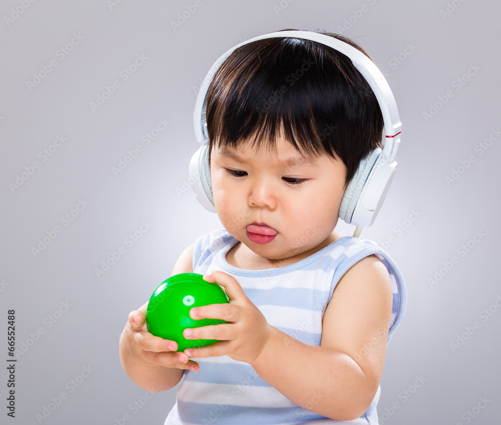 Baby boy with headphone and play with plastic ball Baby boy with headphone and play with plastic ball
