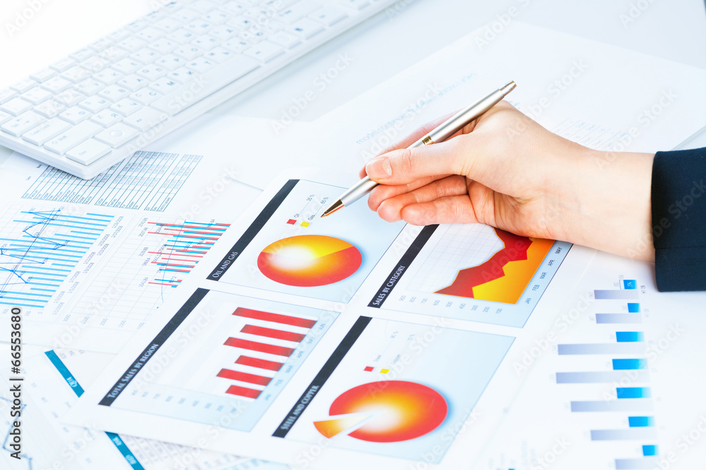 female hand pointing to the financial growth chart female hand pointing to the financial growth chart