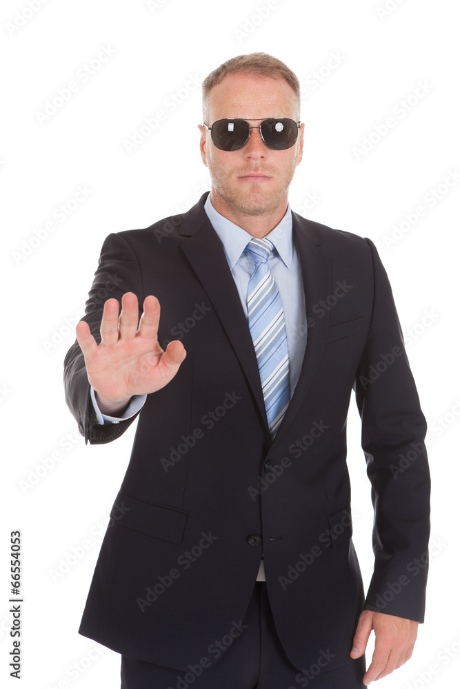 Confident Bodyguard Making Stop Gesture Confident Bodyguard Making Stop Gesture