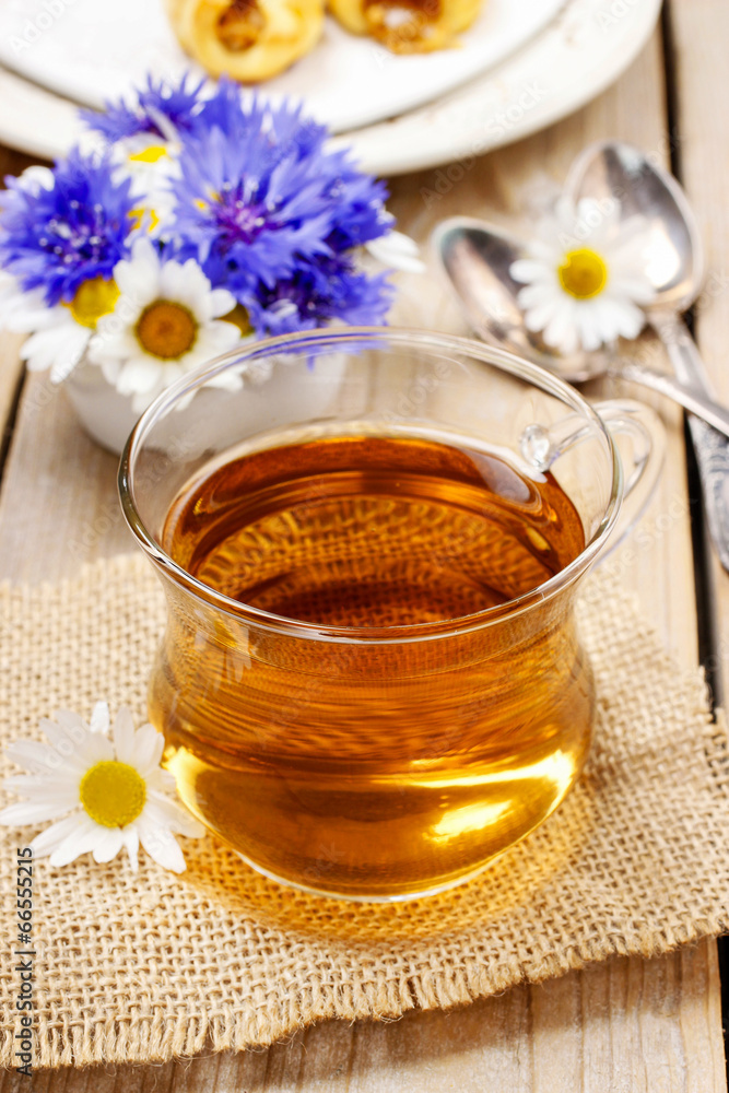 Chamomile tea on wooden table Chamomile tea on wooden table