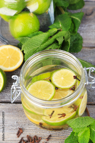 Pickled limes and cloves in glass jar 
