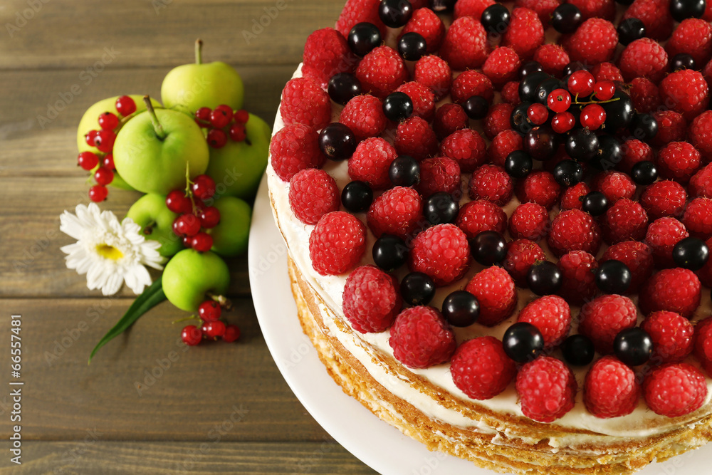 Tasty cake with fresh berries on wooden table Tasty cake with fresh berries on wooden table