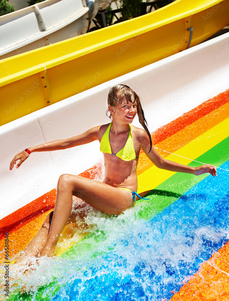 Child in bikini sliding water park. Stock Photo | Adobe Stock