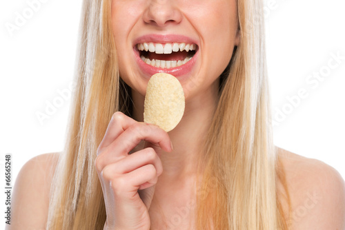 Closeup on happy teenager eating chips