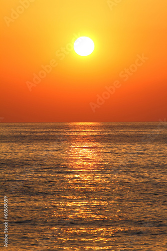 Deep orange color sunset on the beach © viperagp
