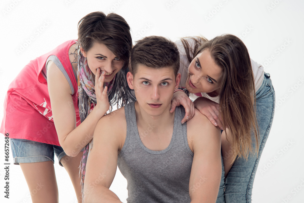 Two attractive teen girls and a boy have fun, isolated on white Two attractive teen girls and a boy have fun, isolated on white