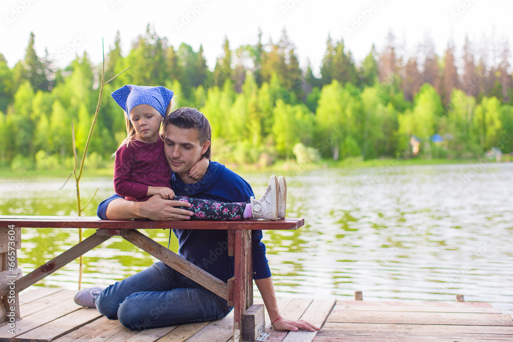 Young father and little adorable girl fishing on the river Young father and little adorable girl fishing on the river