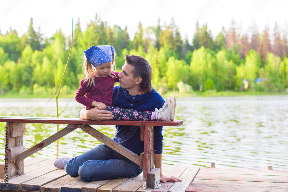 Young father and little adorable girl fishing on the river Young father and little adorable girl fishing on the river