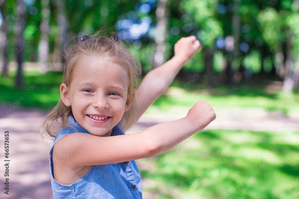 Happy adorable little girl enjoy summer day in the park Happy adorable little girl enjoy summer day in the park