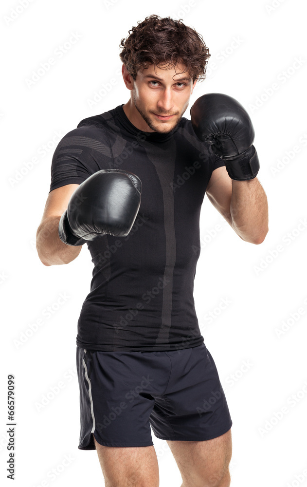 Athletic attractive man wearing boxing gloves on the white