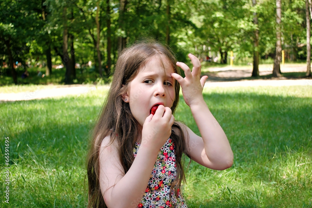 Girl eating fresh strawberries. Girl eating fresh strawberries.
