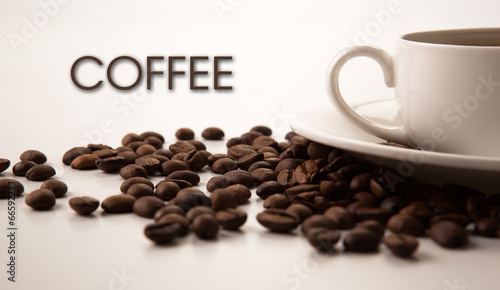 cup of black coffee with roasted coffe beans with title coffee