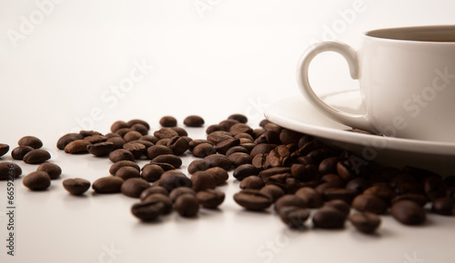 cup of black coffee with roasted coffe beans