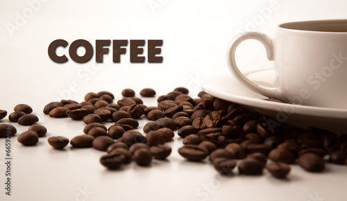 cup of black coffee with roasted coffe beans with title coffee