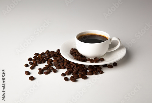 cup of black coffee with roasted coffe beans